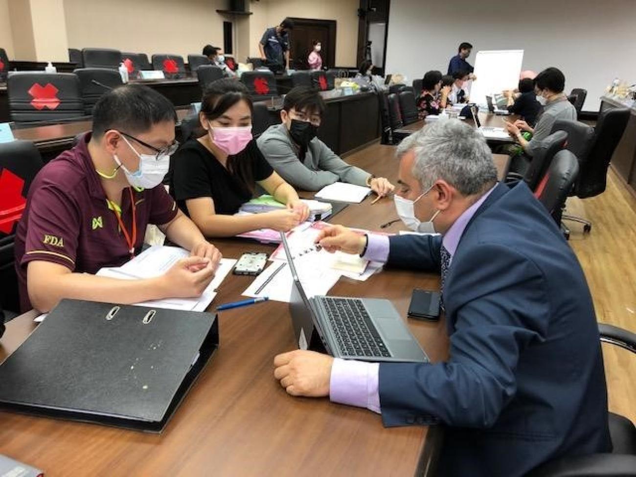 Dr Alireza Khadem, one of the three WHO evaluators, (right)  discuss with officials from the Thai FDA during the assessment mission, on 1 June 2021 