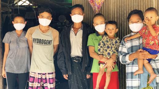 Myanmar family in a temporary shelter in Thailand receives face masks from UNHCR to protect them from the virus